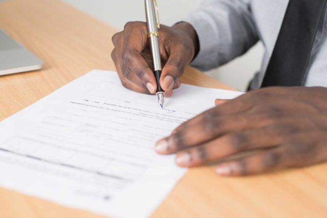 businessman signing a document