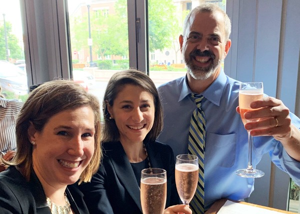 three people toasting with champagne